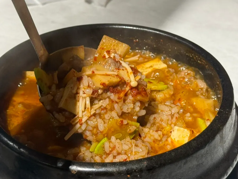 A spoonful of the thick hanwoo doenjang rice broth