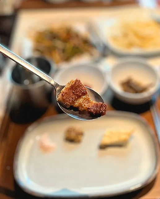 A piece of pork belly dipped in pink salt