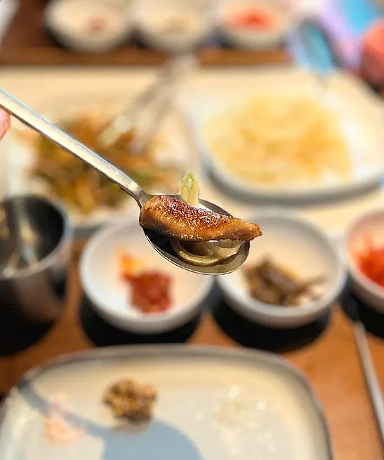 Grilled meat served with pickled onions
