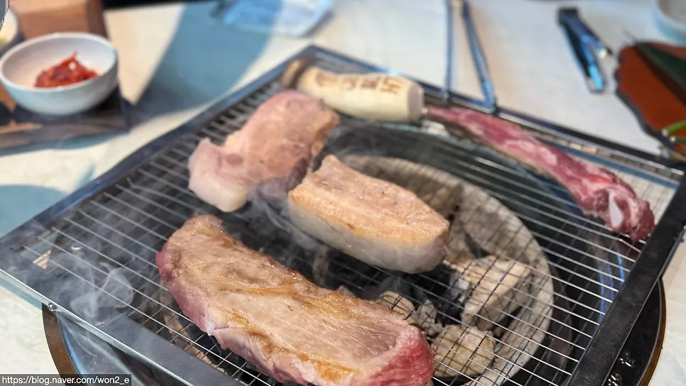 Pork belly cooking over charcoal