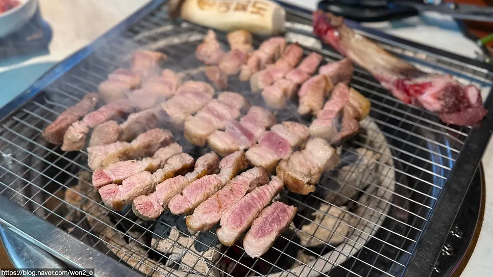 Fresh pork ribs and flower pork neck grilling over charcoal