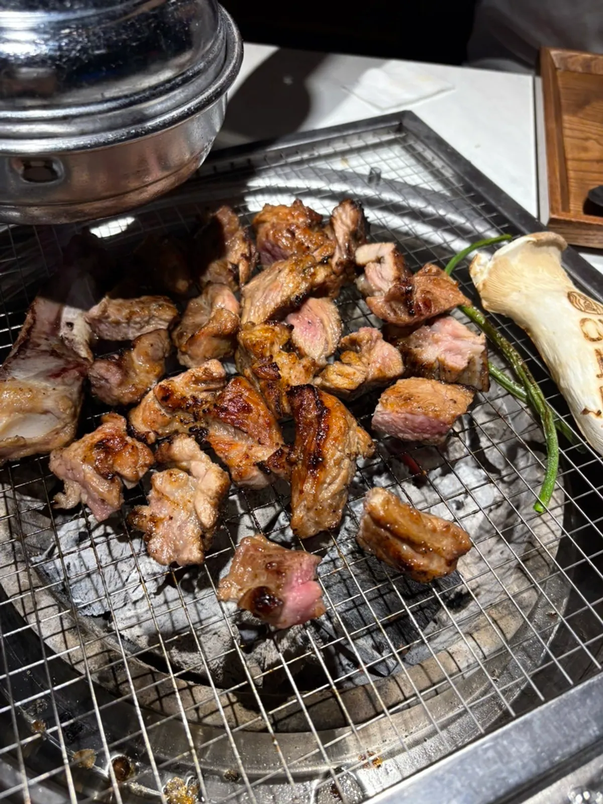 Juicy seasoned pork ribs grilling over charcoal