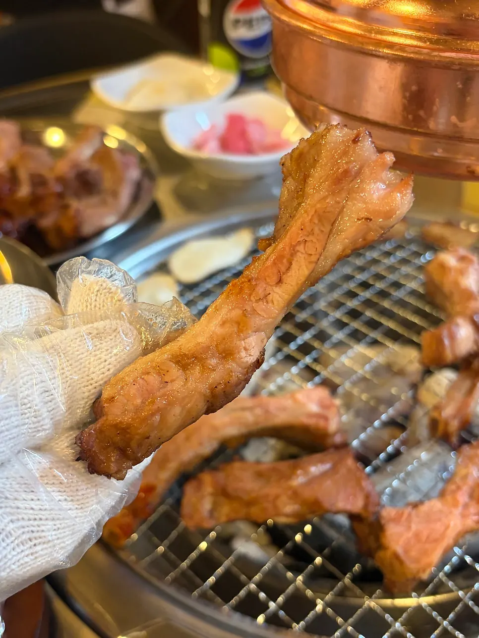 Hands in gloves tearing into jjokgalbi