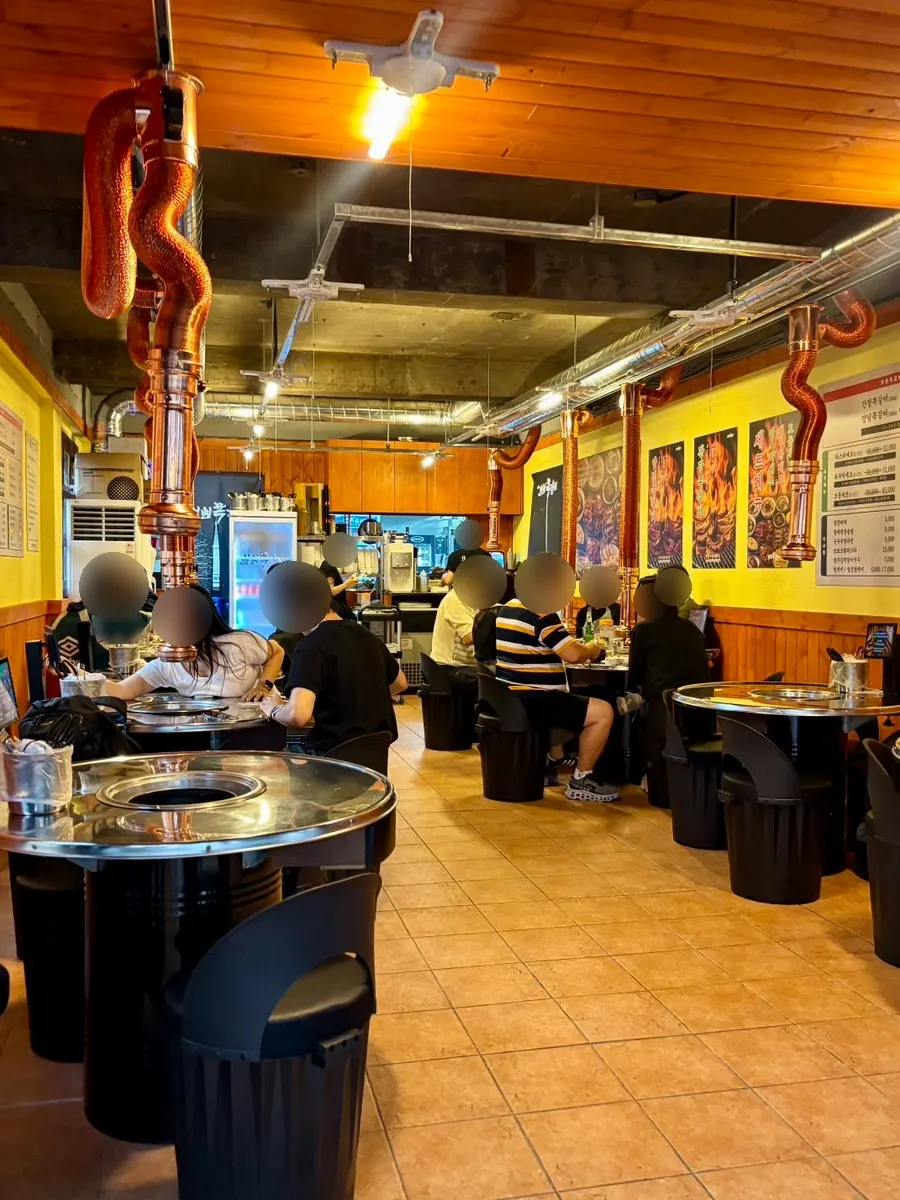 Interior of Champpoppo Jjokgalbi Hapjeong Branch with customers on a weekday evening