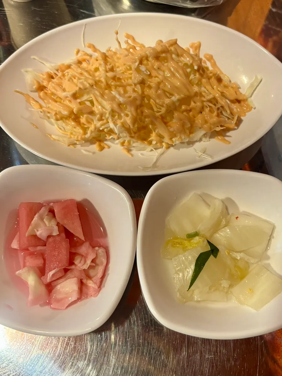 Basic side dishes: cabbage salad, pickled radish, baek-kimchi, and pickled onion