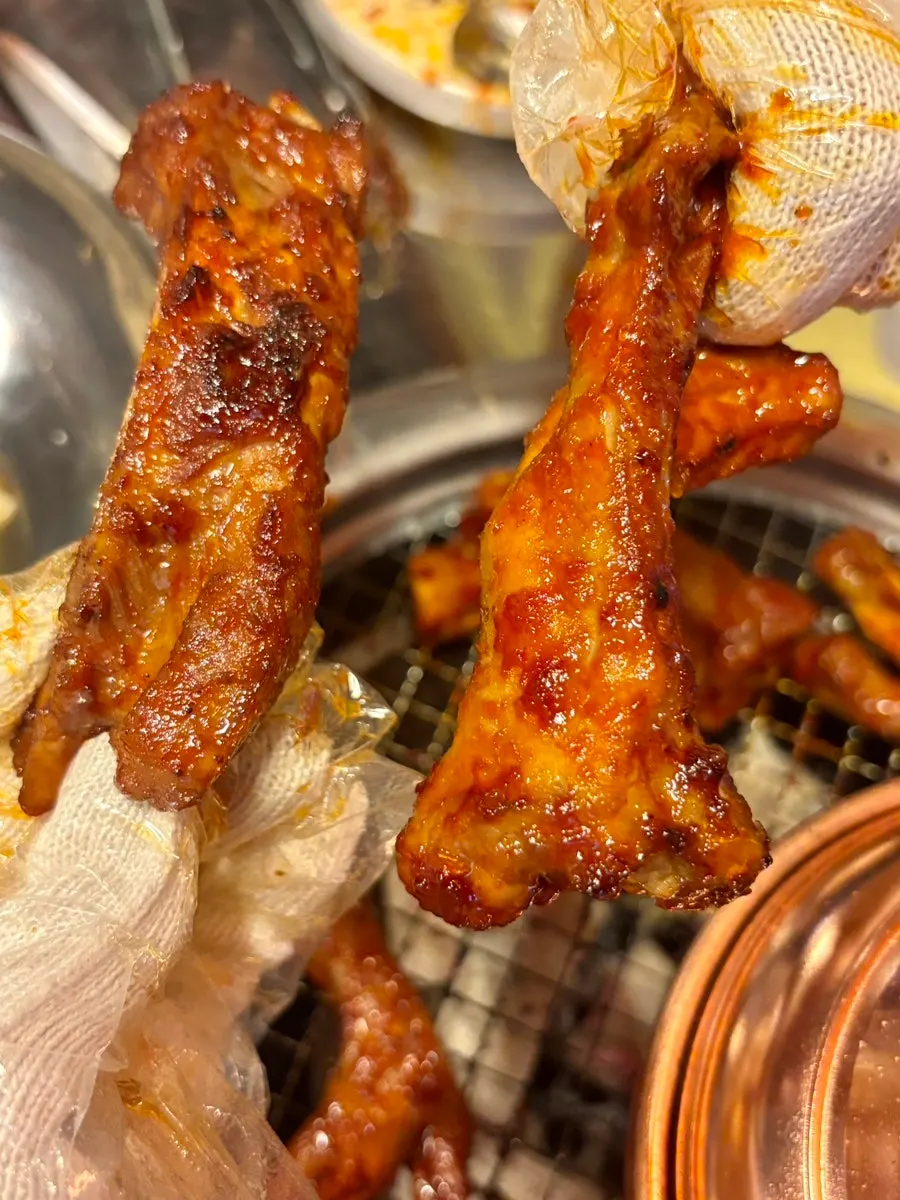 Geommaep seasoned pork ribs grilling over charcoal