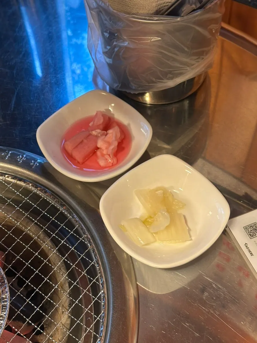 Pickled onion and other basic side dishes at Champpoppo Jjokgalbi