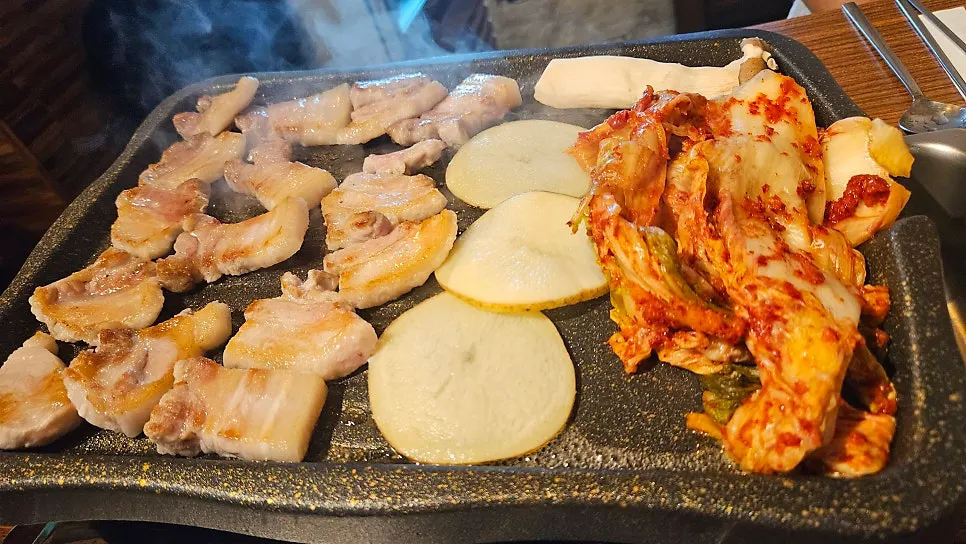 Cooked pork belly with kimchi cooked alongside it