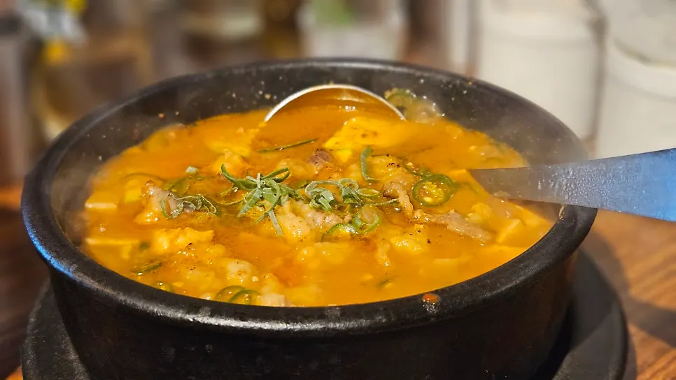 A well-grilled piece of pork belly with kimchi
