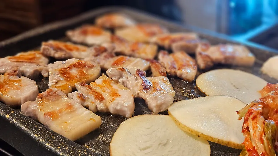 Bite of pork belly with kimchi