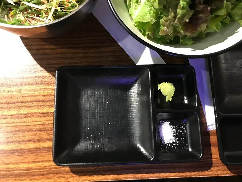 A piece of pork topped with wasabi