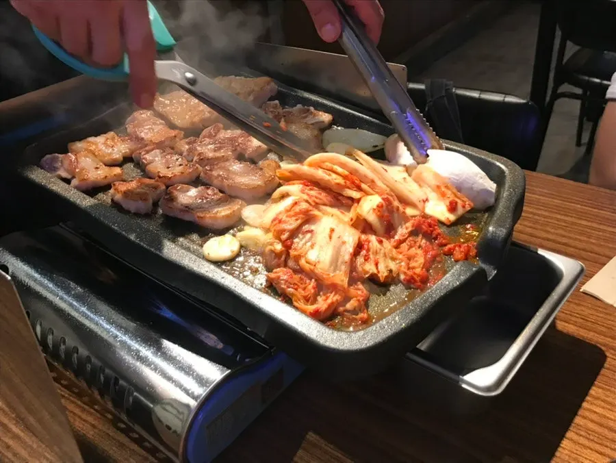 Pork belly and kimchi grilling together