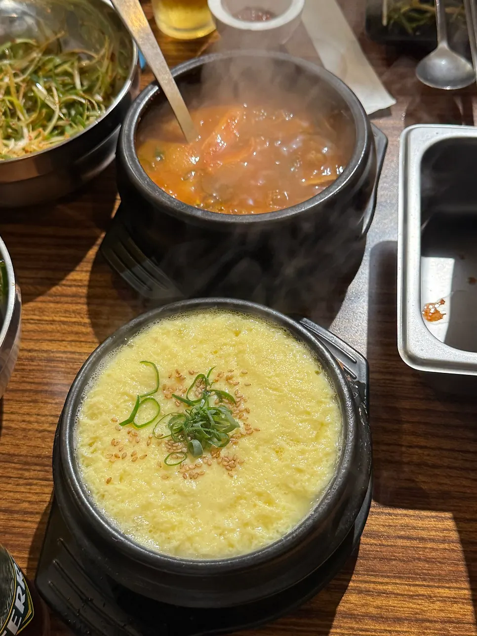 A grilled bite of pork neck served with kimchi