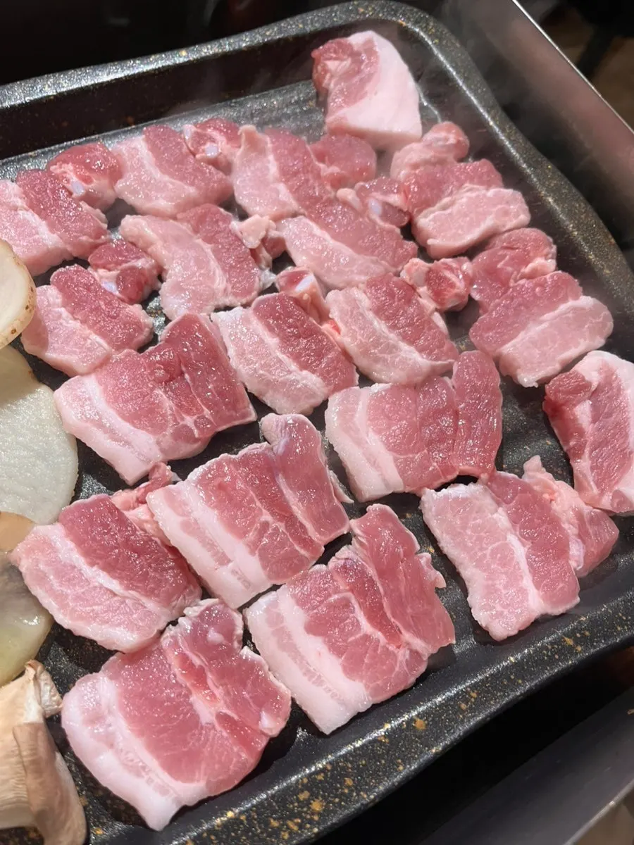Staff grilling the kimchi samgyeopsal