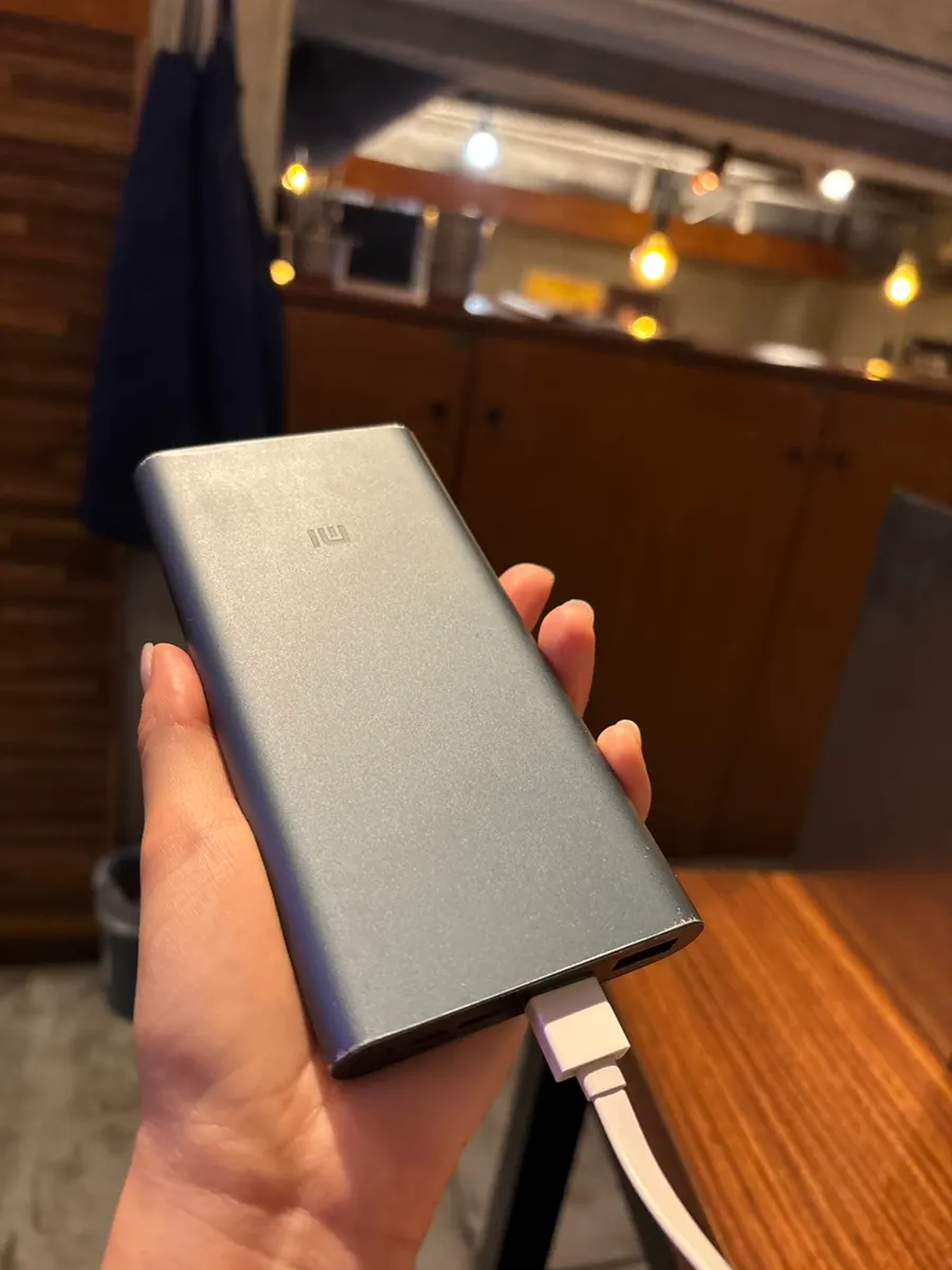 A portable charger borrowed from the restaurant at the table