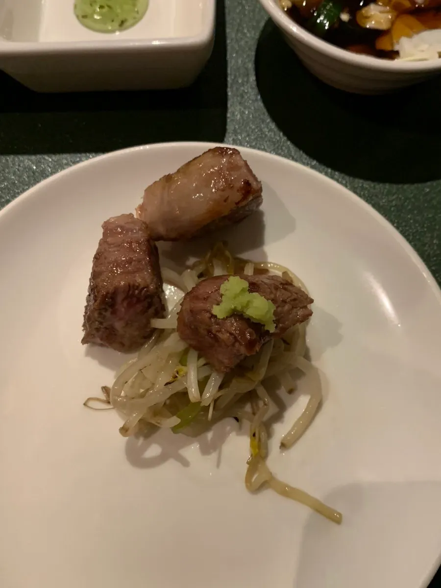 A piece of grilled lamb rib placed on the small plate