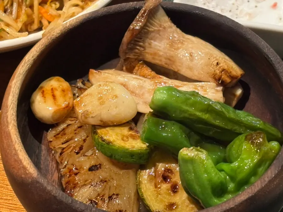 Mixed vegetables including king oyster mushroom, garlic, and shishito peppers