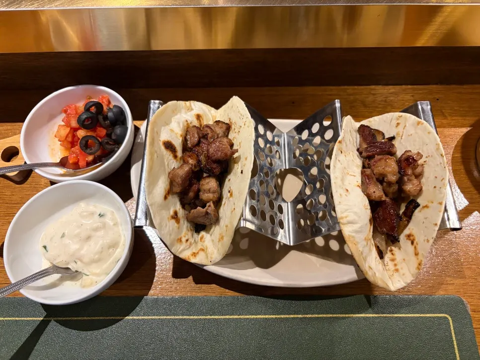 Lamb taco topped with tomato salsa and mayonnaise