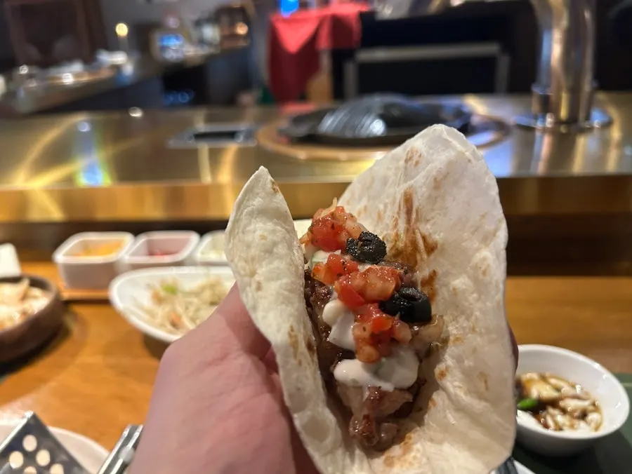 A bite of lamb chop dipped in sauce