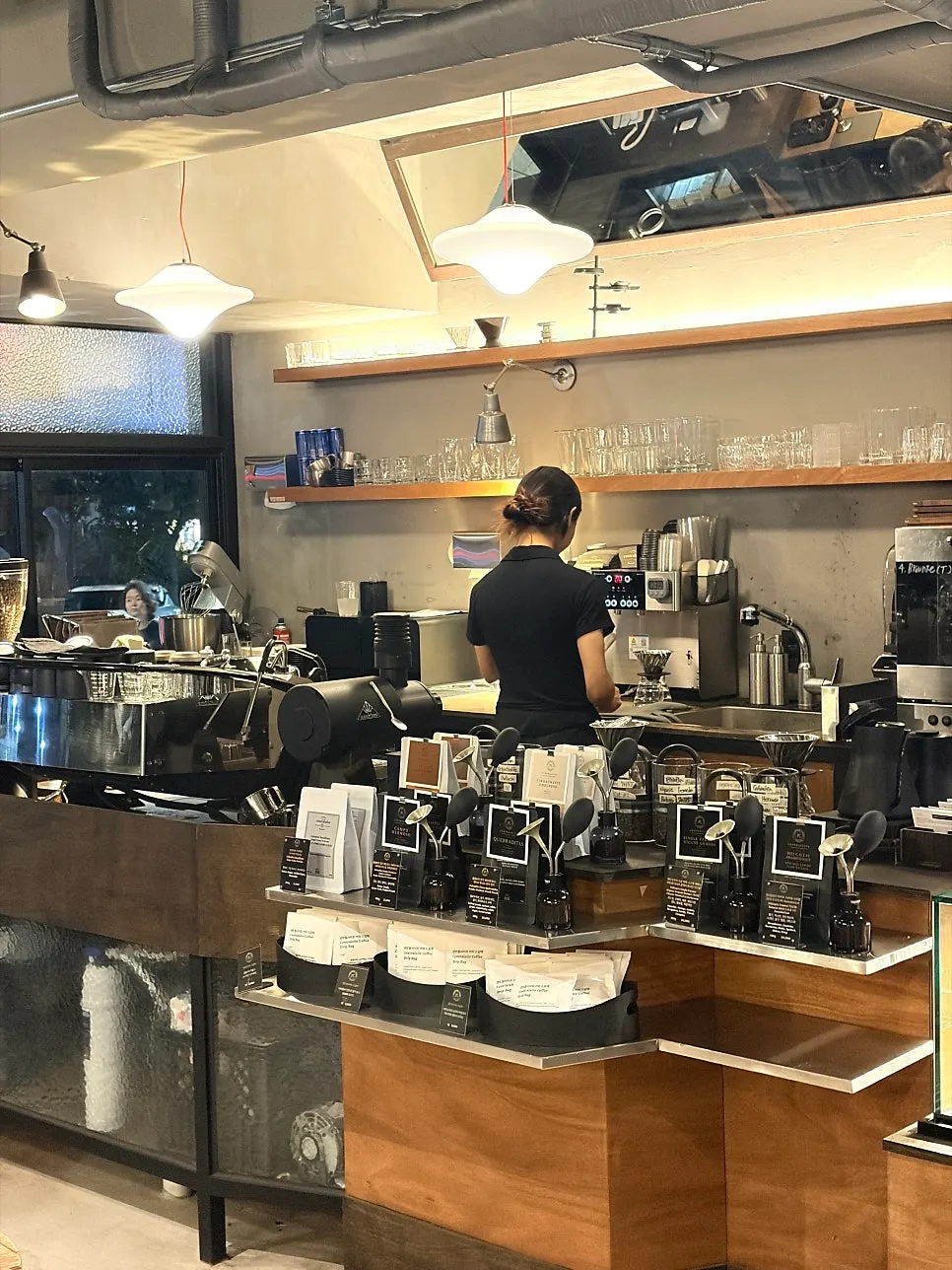 Barista brewing hand-drip coffee at the counter