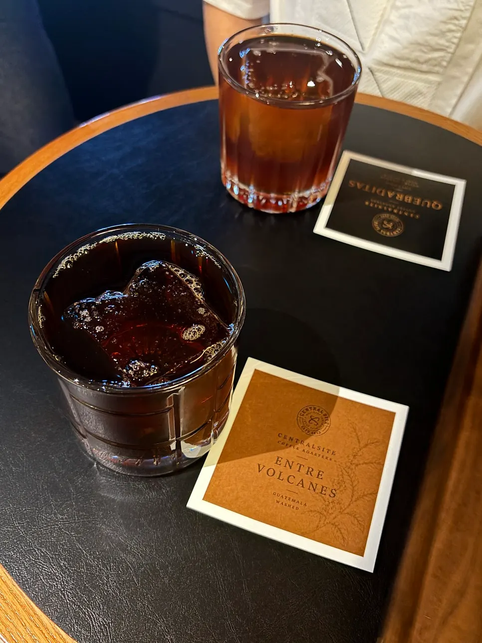 Two hand-drip cups with large ice cubes