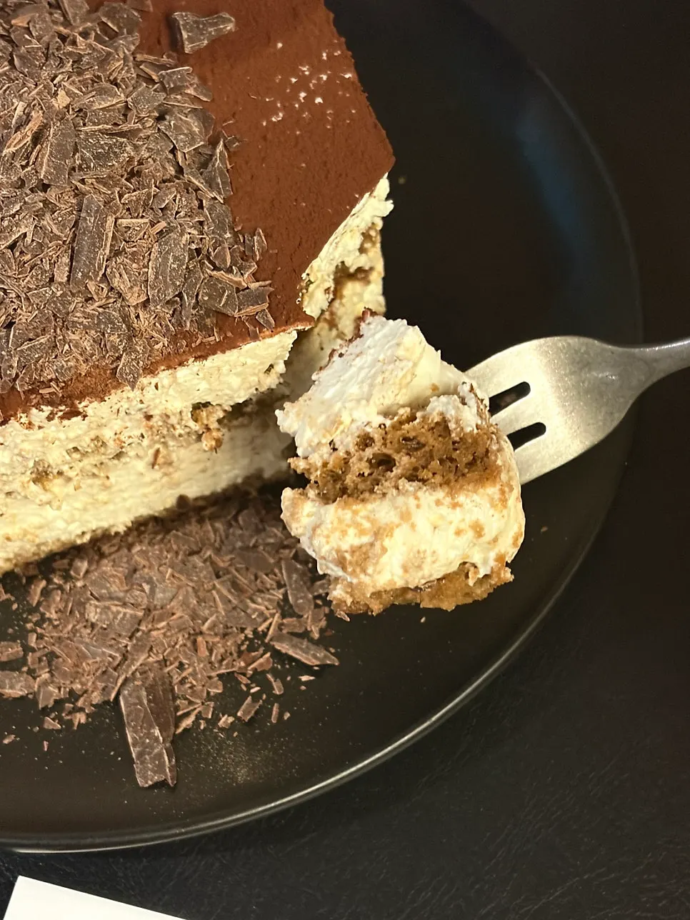A slice of classic tiramisu served with coffee