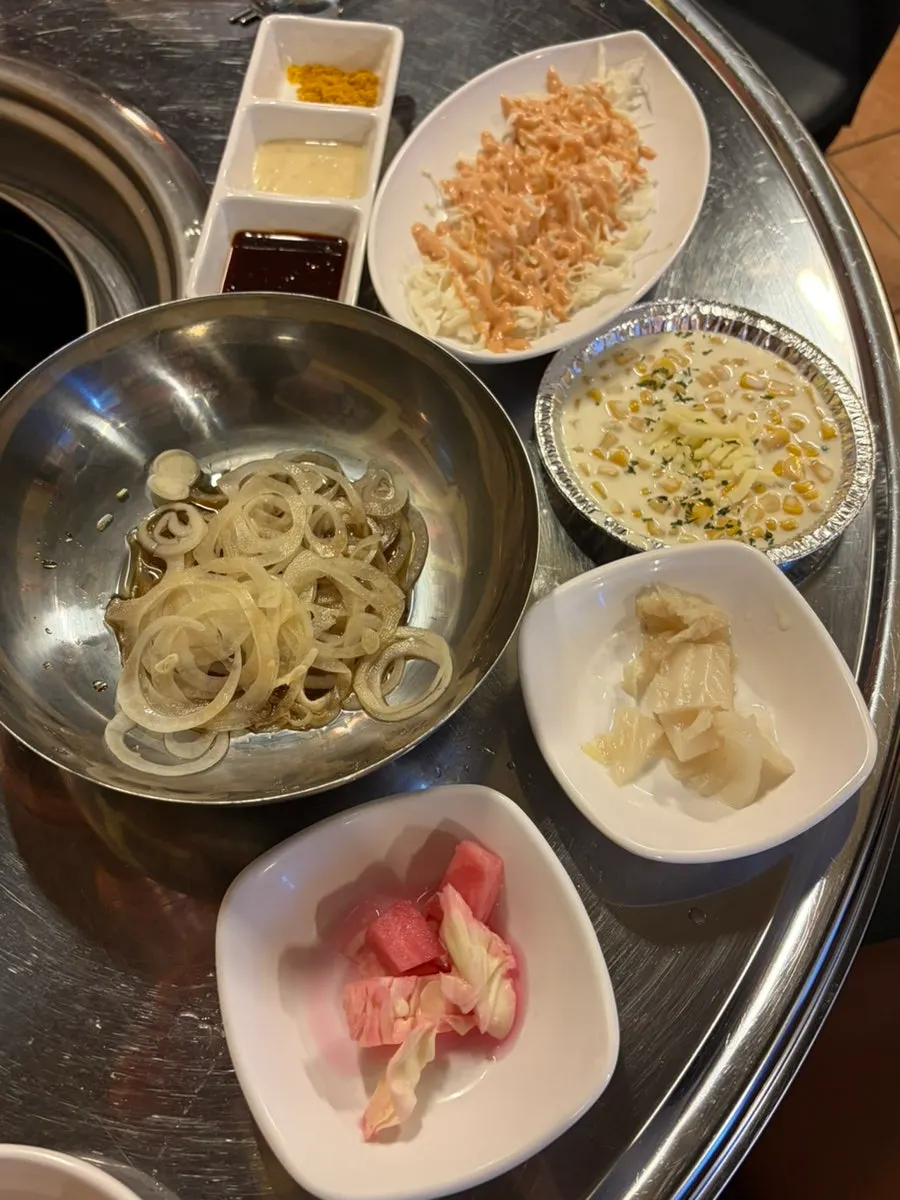 Basic side dish spread including corn cheese and baek-kimchi