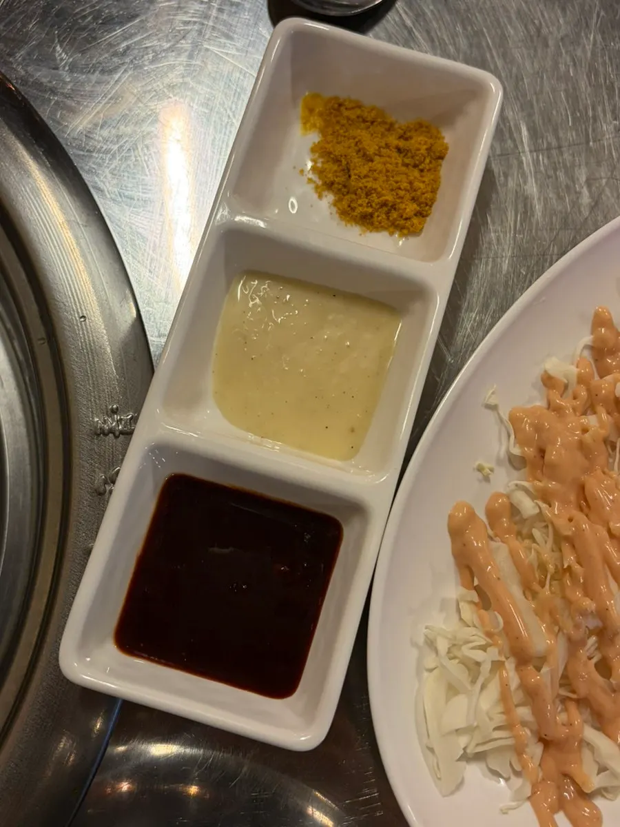 Side dishes including pickled onion and sauces