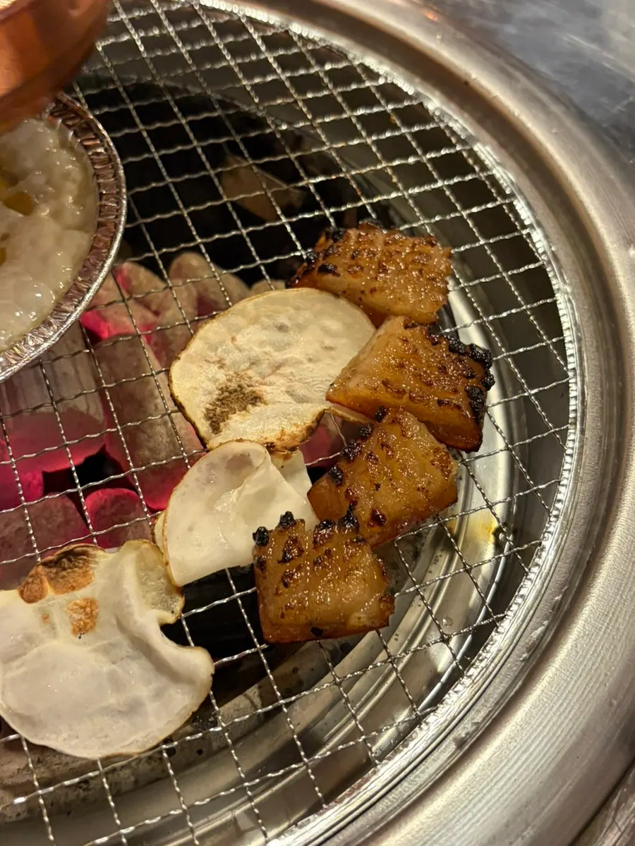 Pork skin and potato slices grilling on the plate