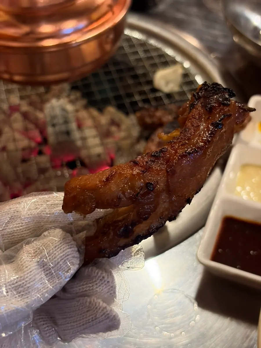 Close-up of jjokgalbi glossed with sauce
