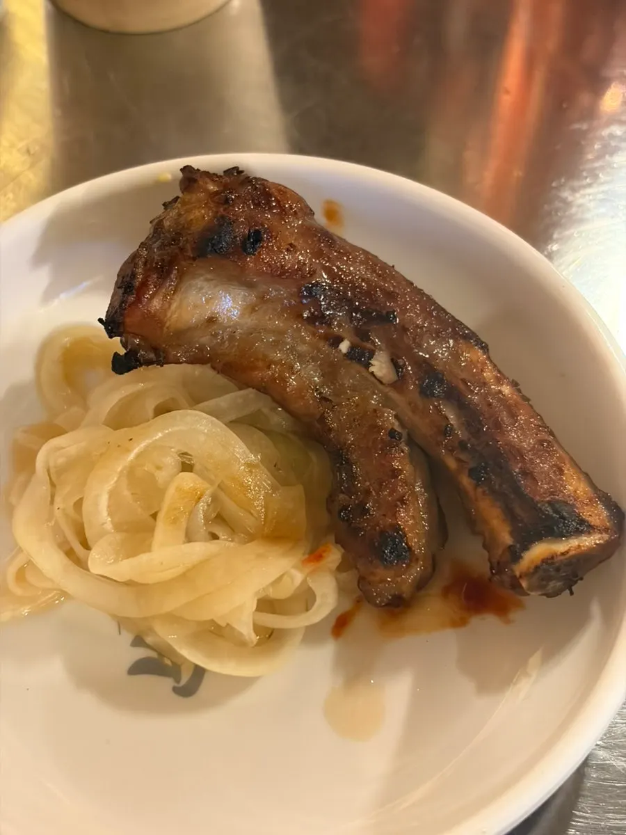 Jjokgalbi picked up alongside pickled onion