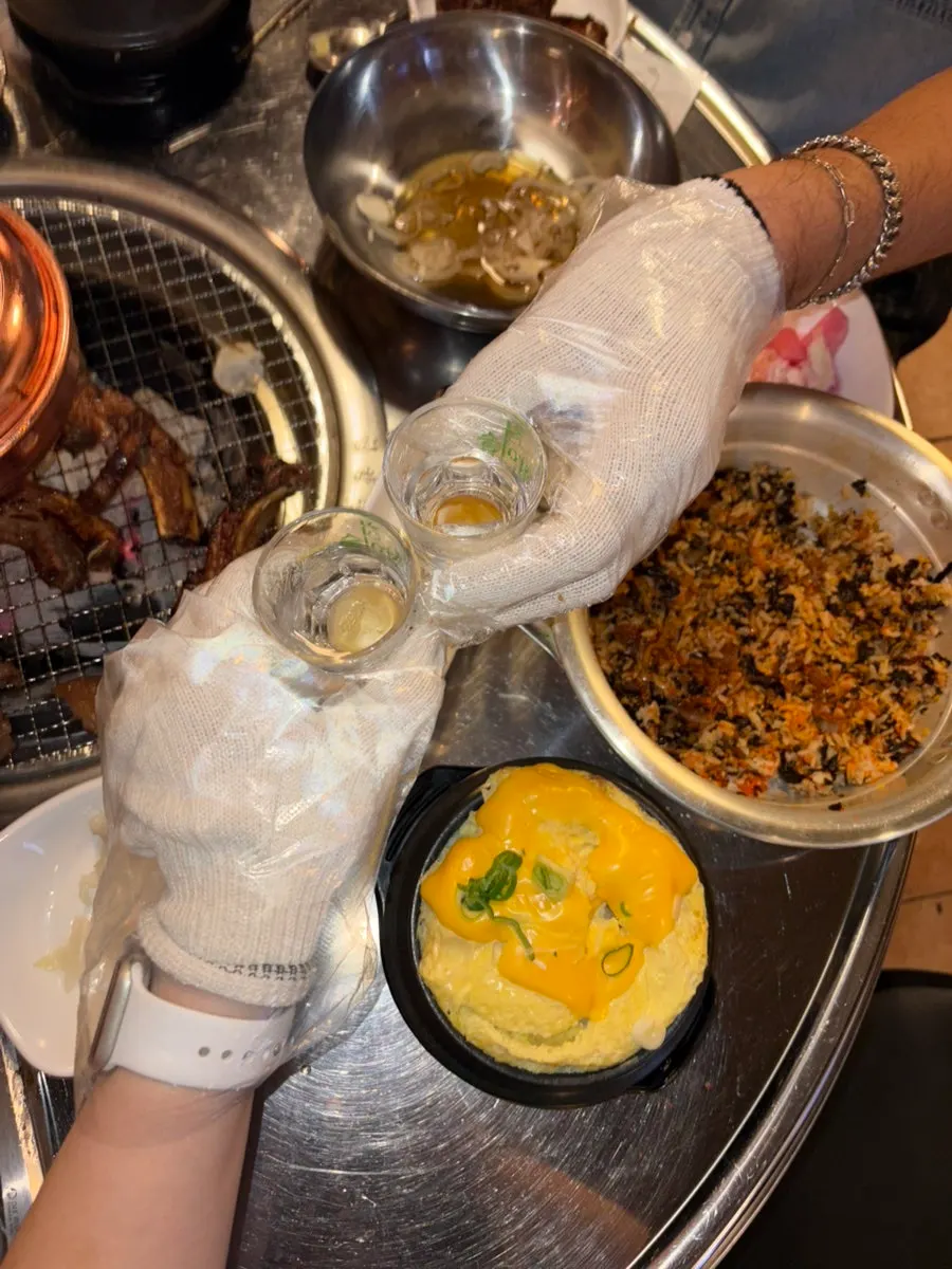 Jjokgalbi spread set alongside soju glasses