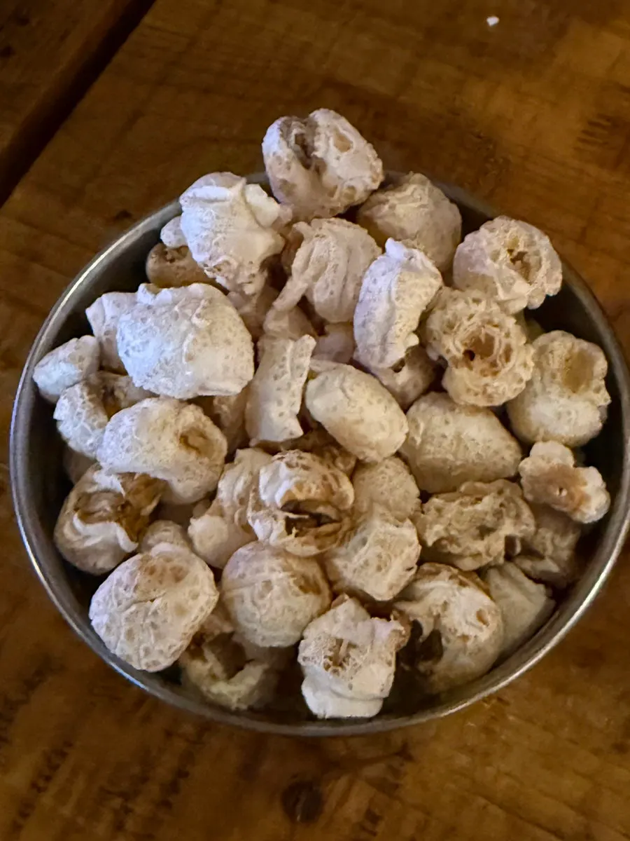 Basic side dish of gangnaengi corn puffs and soju at Bako Jumak