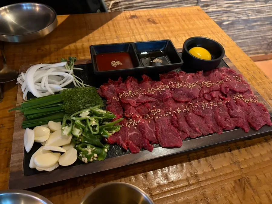 Large beef sashimi from Bako Jumak served with garnish vegetables