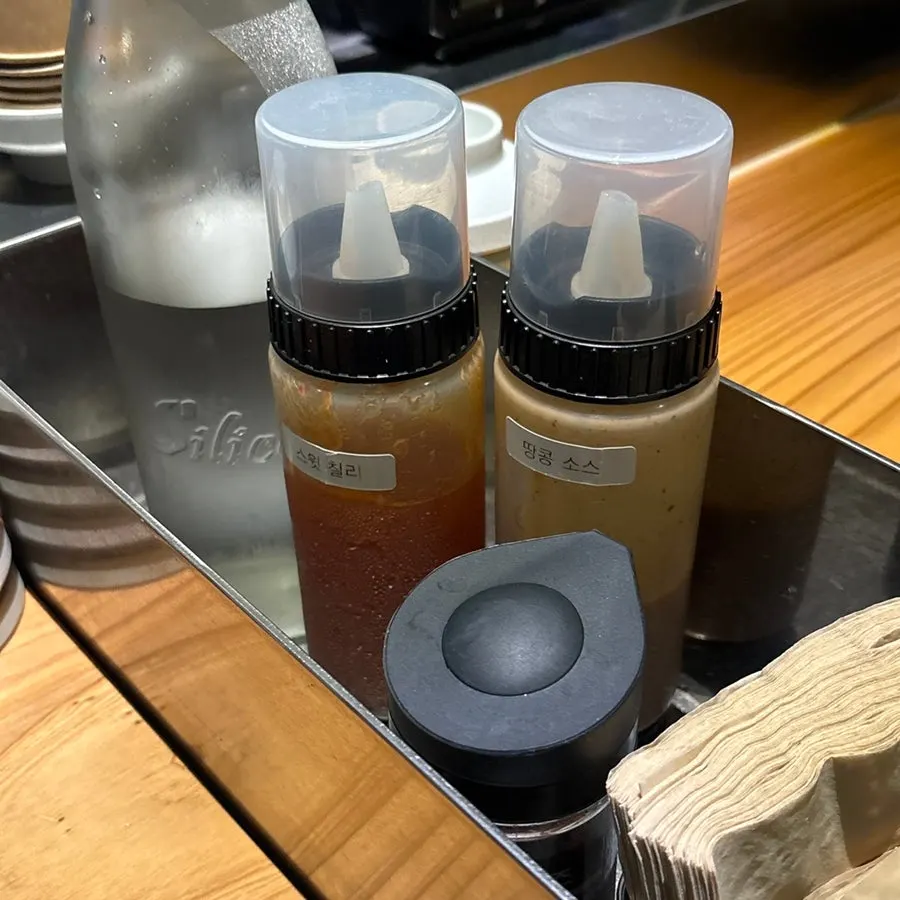 Peanut sauce and chili sauce placed at each table