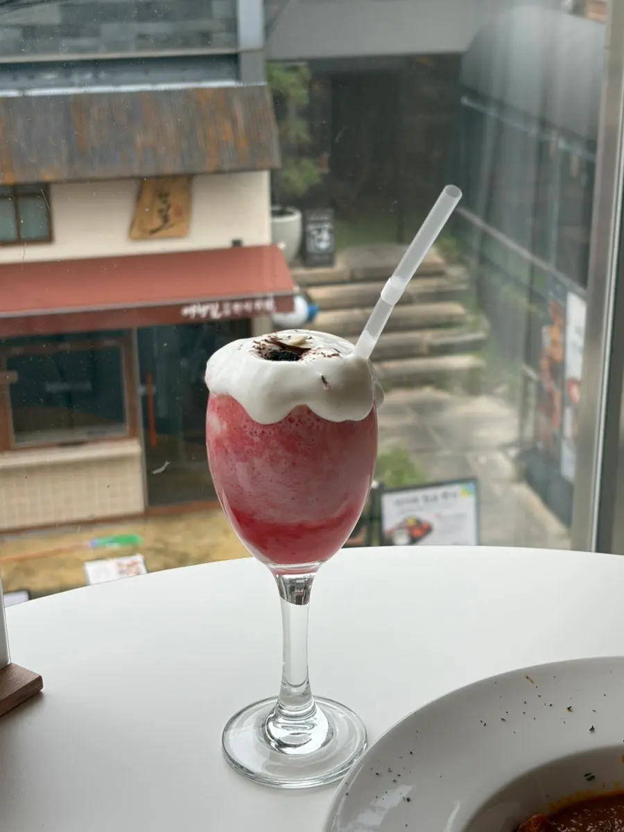 Strawberry lassi topped with cream