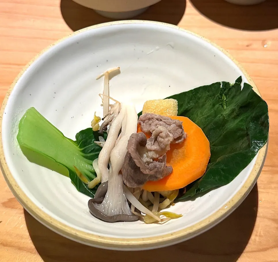A shabu-shabu wrap of bok choy, bean sprouts, and meat