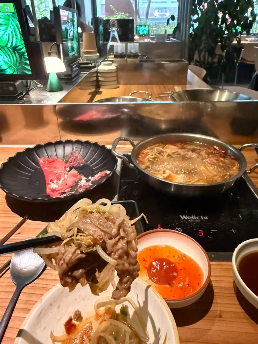 Mala shabu broth with added minced chili and garlic