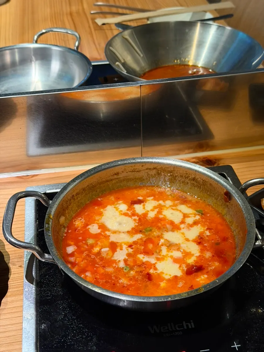 Pot of mala shabu-shabu simmering with ingredients