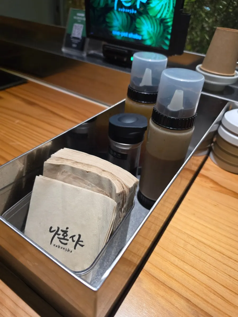 Individual pot and broth set up at a single seat