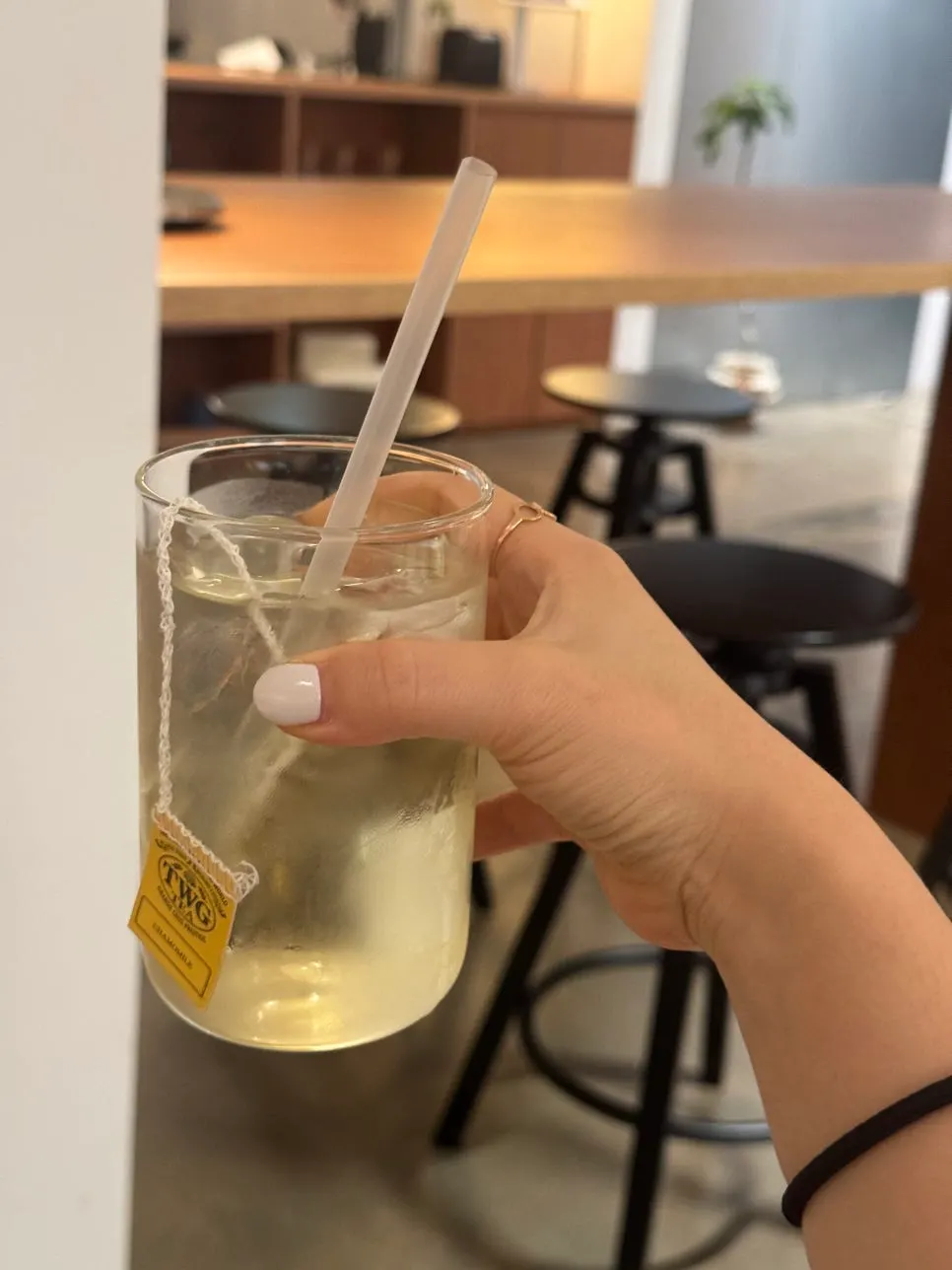 Iced chamomile tea served with a tea bag dish