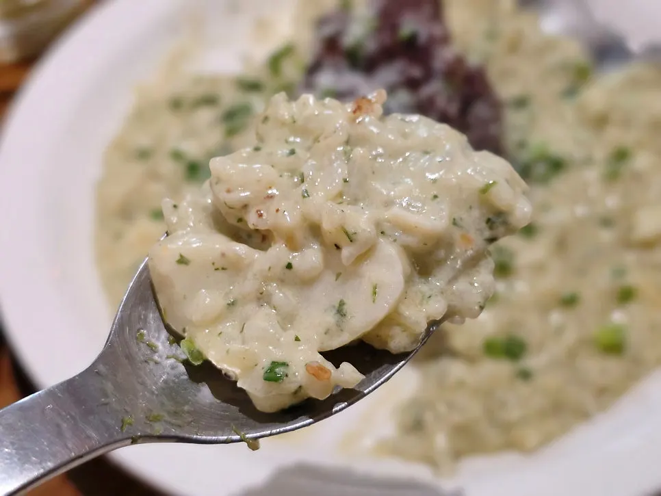 A spoonful of short rib basil risotto lifted up