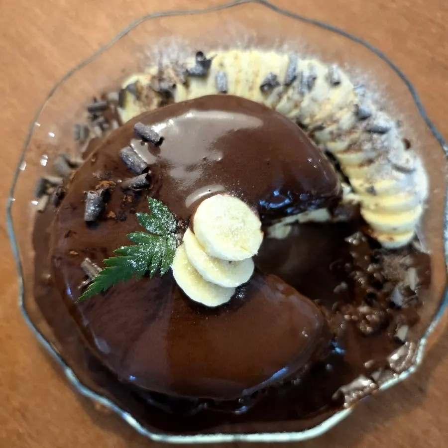 Chocolate served with soufflé and banana