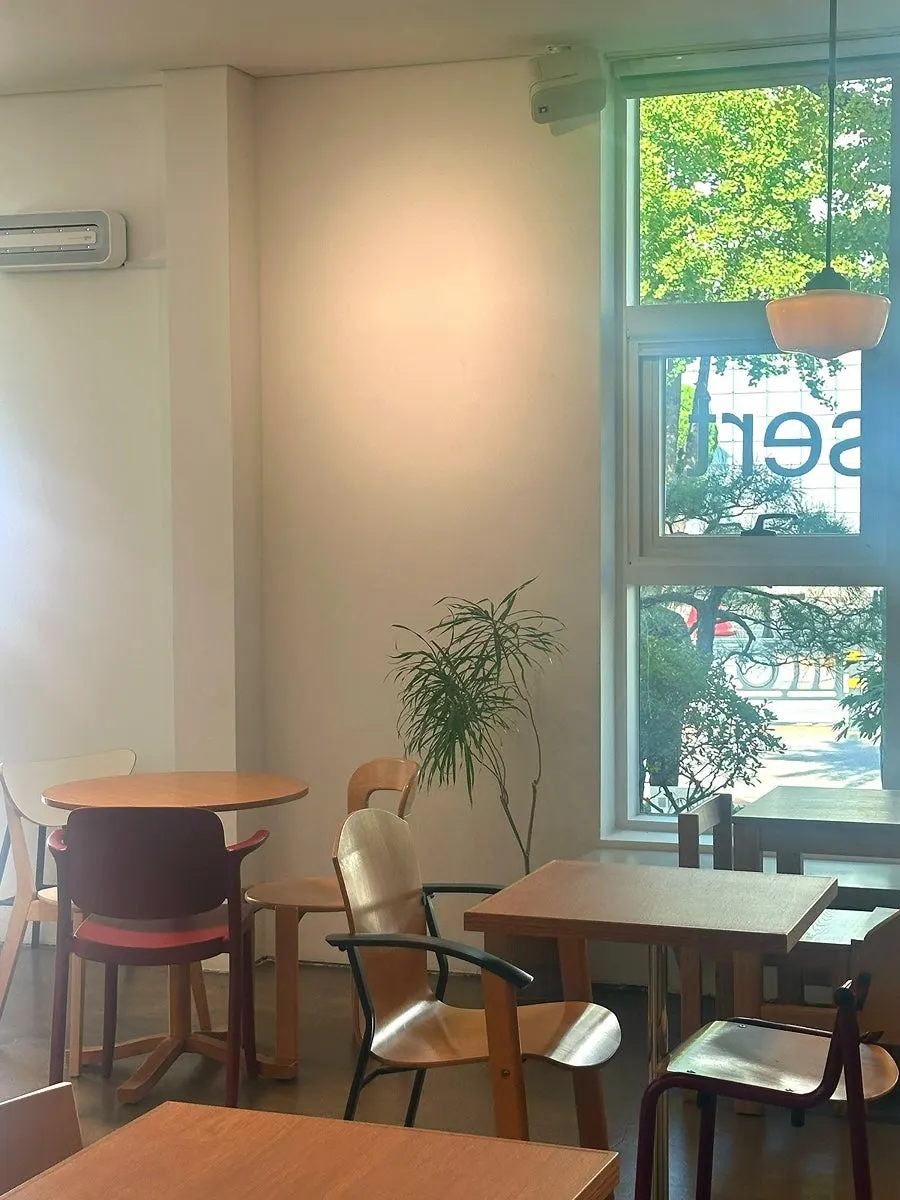 Petrico interior in wood tones with yellow lighting