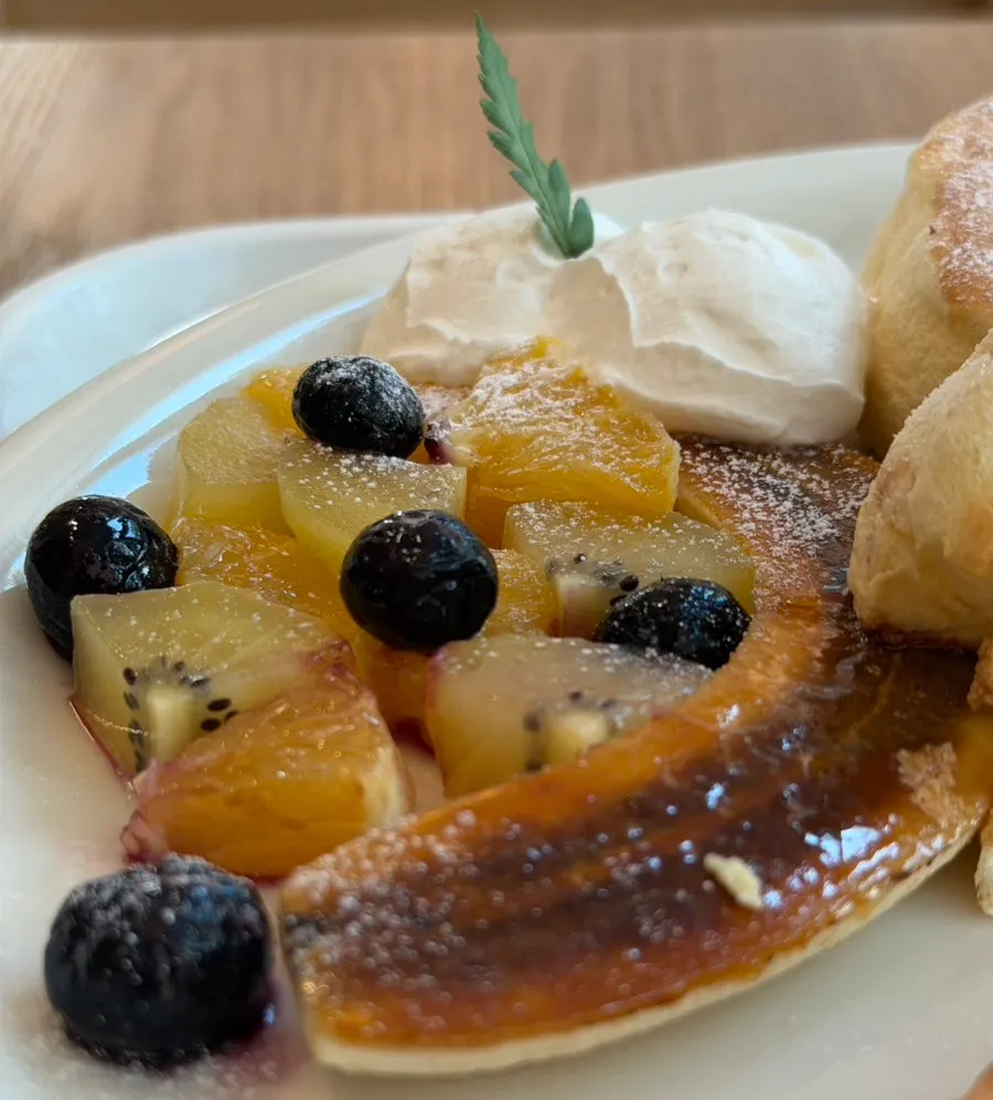 Pancake served with fruit and cream