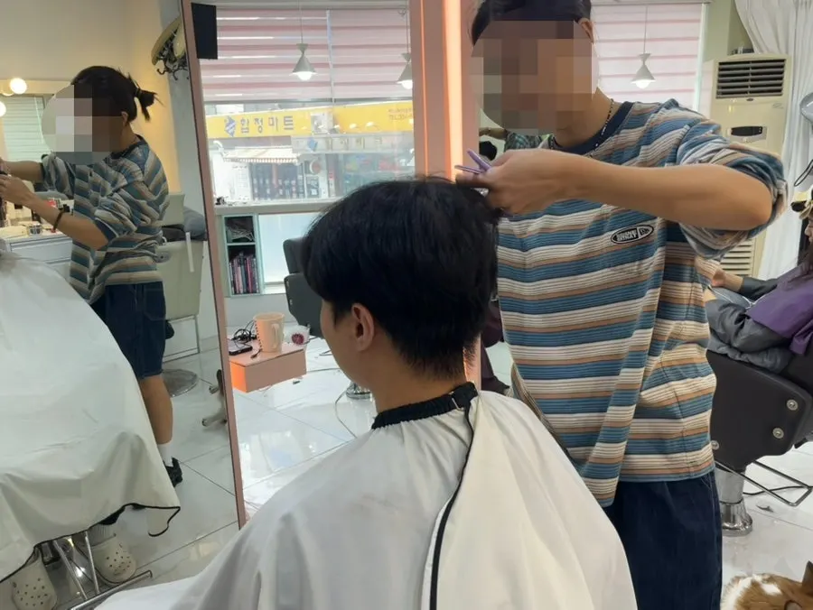 Side hair being smoothed down with the perm