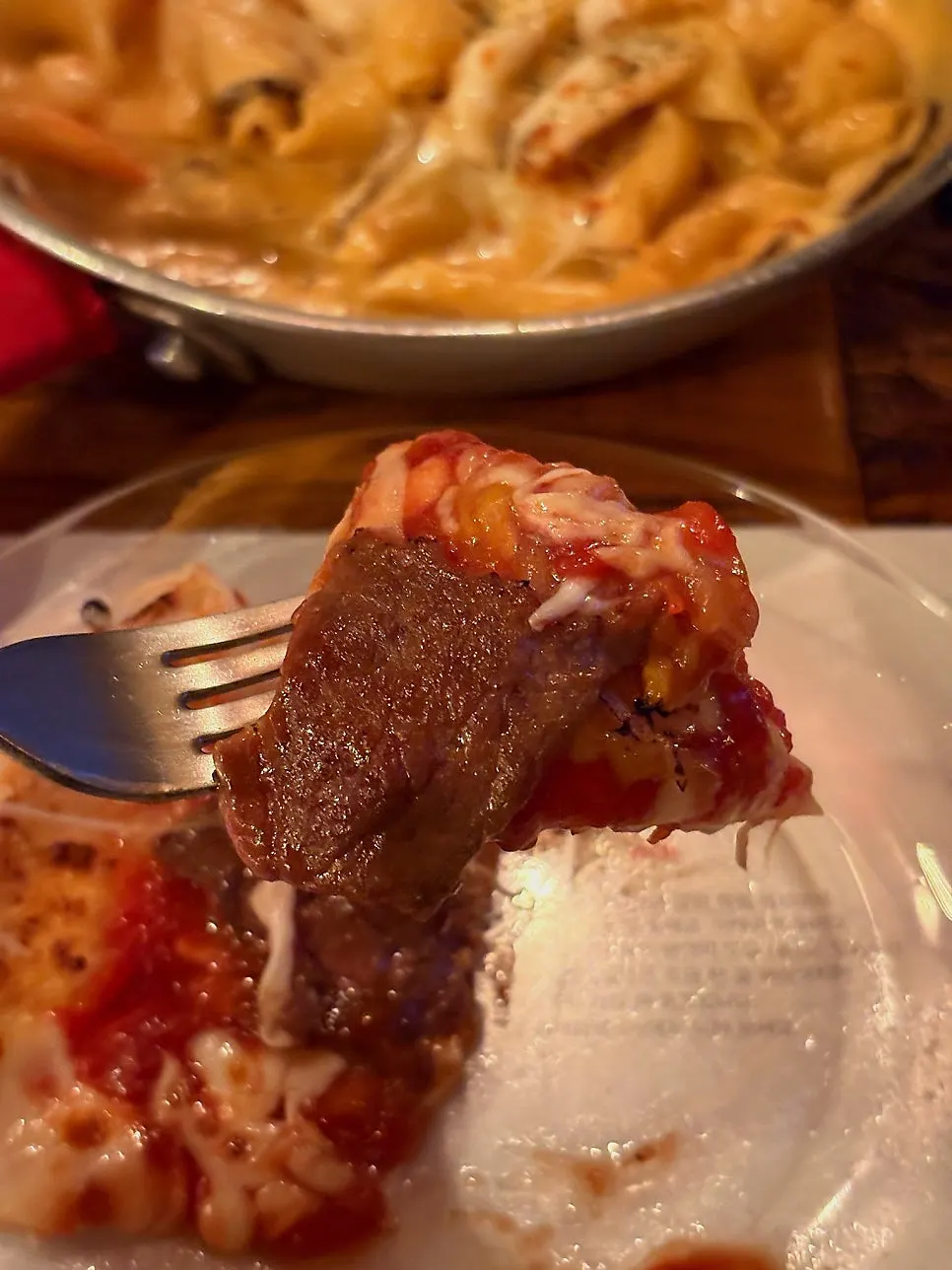 A slice of Manjo pizza with beef toppings