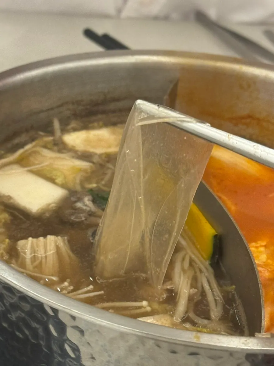 Flat glass noodles and vegetables in shabu broth