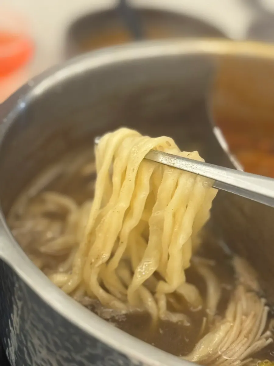 Kalguksu cooking in rich broth