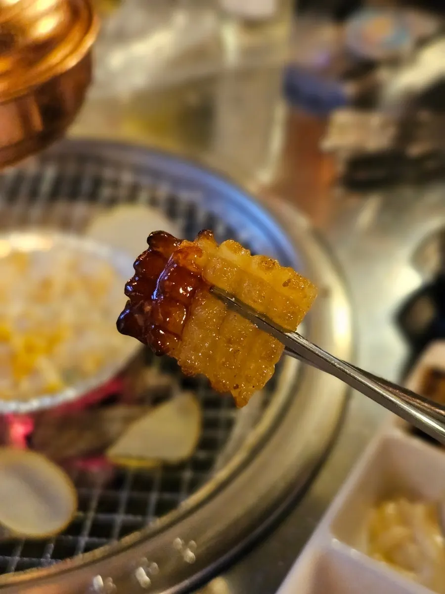 A spoonful of cheese steamed egg from the stone pot